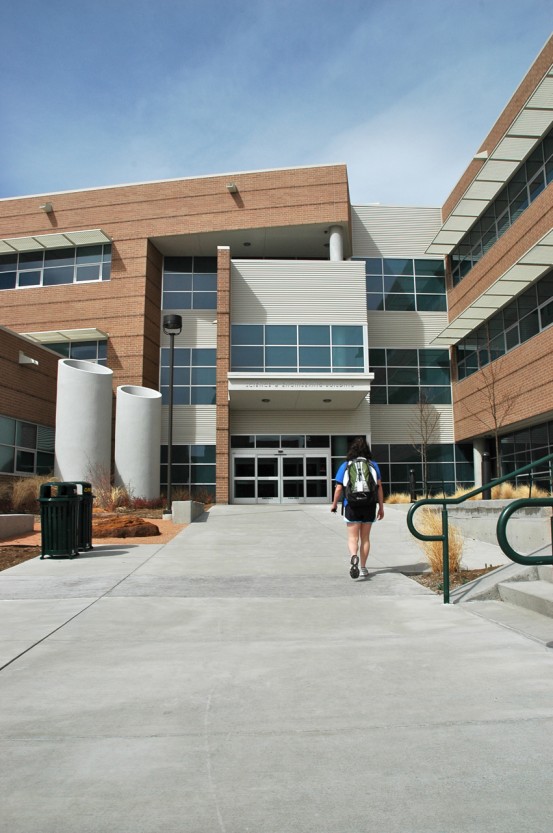A student walks to the Science & Engineering Building main entrance