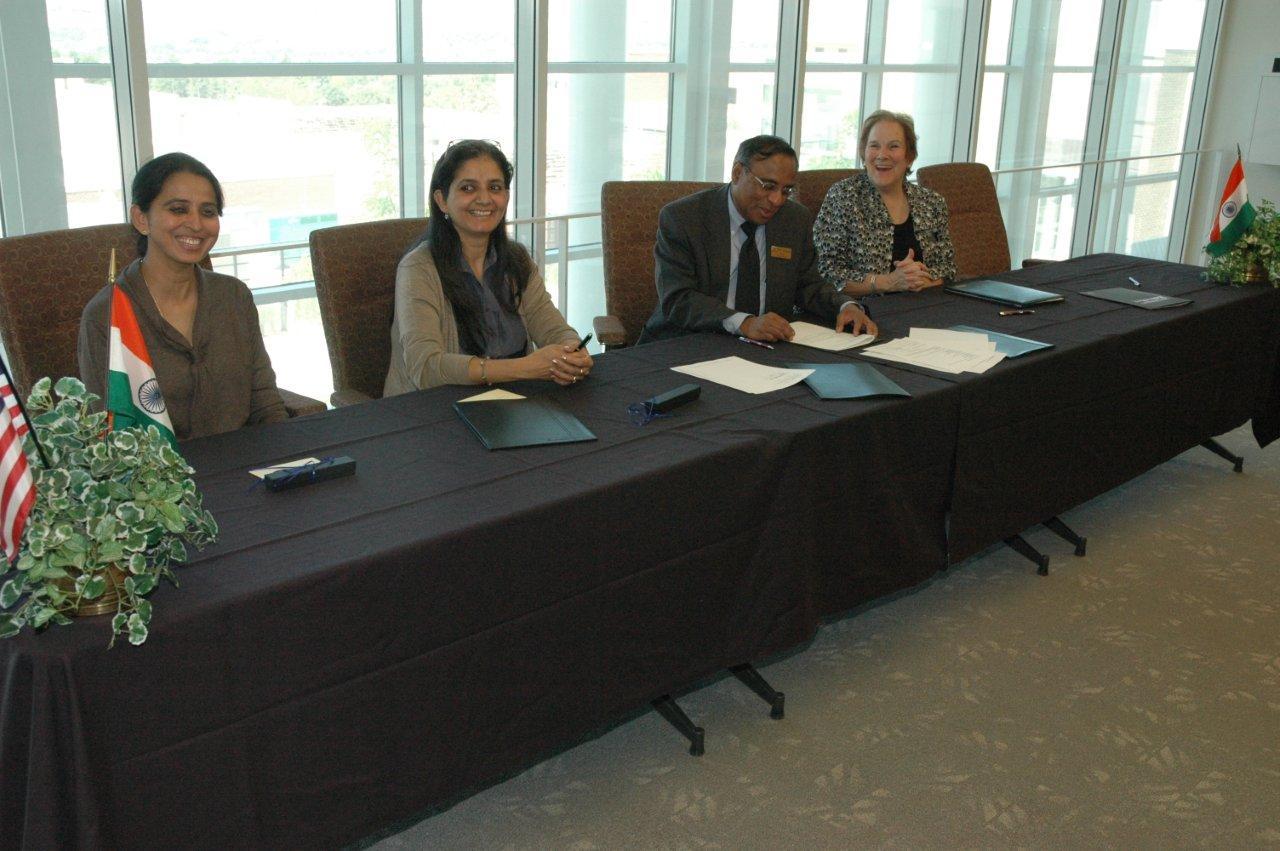 Peg Bacon and Dandapani sign the MOU