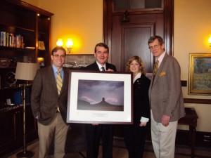James Law, left, a member of the 2012 class, Sen. Michael Bennet,  Brenda Barr of National Geographic and Steve Jennings, associate professor, in Sen. Bennet's office. Bennet is holding a picture given to him as part of a National Geographic award.