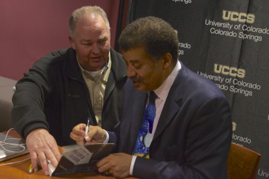 Tyson signed posters and books while taking pictures with fans.
