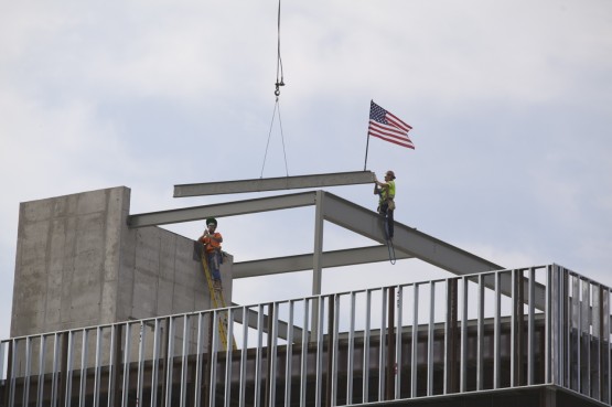 The signed beam is lowered into place atop the Lane Center for Academic Health Sciences
