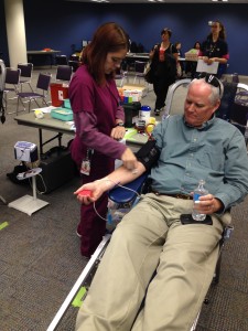 Stacey Hicks, left, a Bonfils phlebotomist, prepares Ron Honn Wednesday morning for a blood donation. 