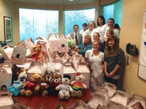 Student nurses pose with the more than 160 bears built delivered to Children's Hospital at Memorial Central.