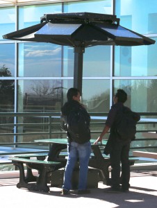 Two students examine the new table on the Upper Plaza.