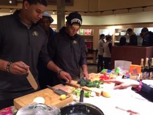 Members of the CU Buffalo football team learn how to prepare healthy meals.