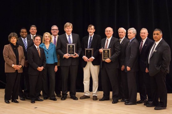 The CU Board of Regents pose with three distinguished professor recipients.