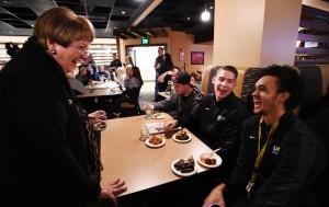 Chancellor Pam Shockley-Zalabak congratulates Derrick White and Alex Welsh (right to left) for winning the RMAC Championship. The UCCS men's basketball celebrated a trip to the NCAA Division 2 tournament and a number 4 seed in their bracket during a watch party March 8, 2015. (JERILEE BENNETT/THE GAZETTE)