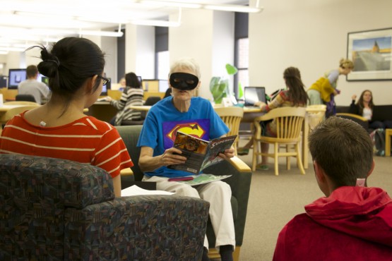 Peggy Satterfield reads aloud to students from Mravel Comics' "Superboy"