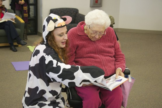 VAPA student Taylor Gross dressed as a cow while assisting Lola Satterfield read a Dr. Seuss story