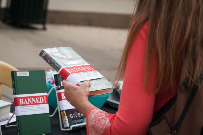 A student reviews a book title Tuesday morning during Banned Books Week.
