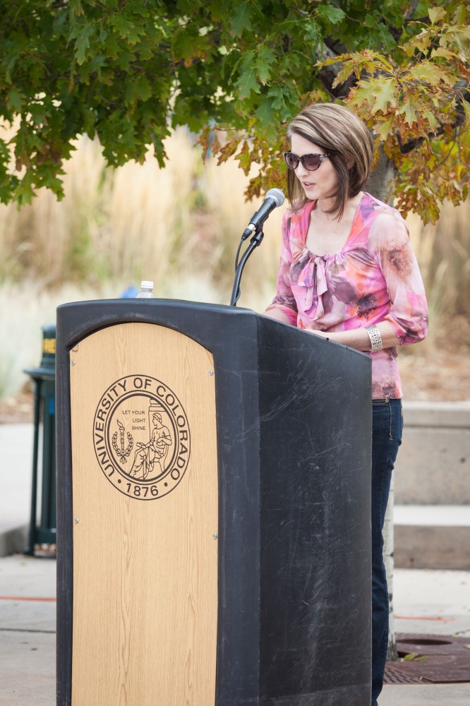 Christine Robinson, instructor, Department of English, reads aloud on El Pomar Plaza during Banned Books Week.