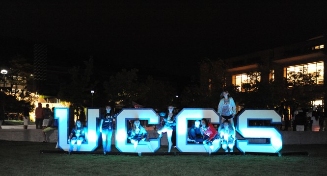 Students sit in large U-C-C-S letters during the Homecoming spirit rally