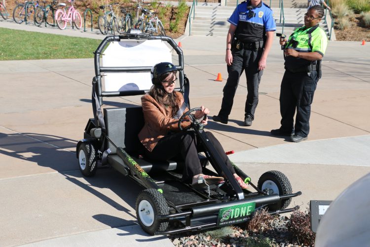 Audrey Jensen, a UCCS student, winces as she drives off course in the simulated impaired driving vehicle.