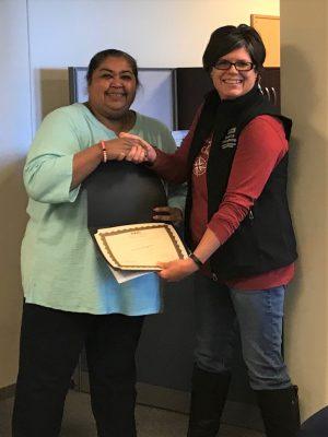 Rogers receives the Employee of the Quarter award from Sabrina Weinholtz