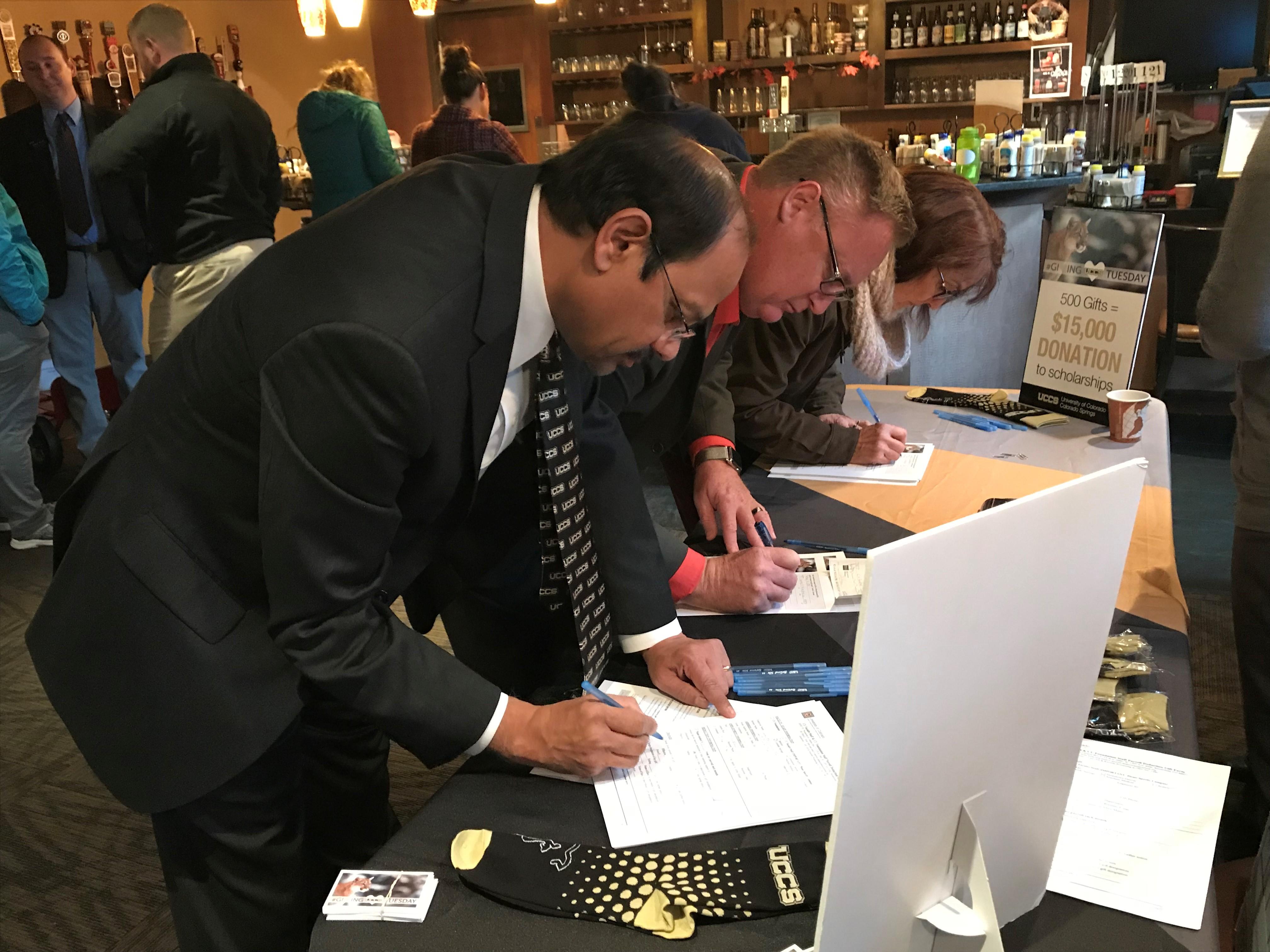 Chancellor Venkat Reddy makes his Giving Tuesday donation during the kickoff breakfast
