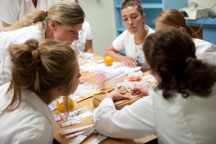 Nursing and health sciences students around a table.
