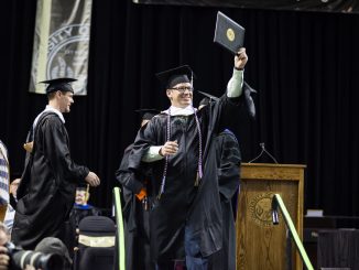 A master's student receives his degree during the 2018 spring commencement ceremony