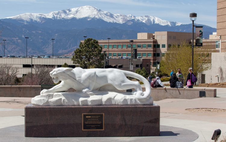 Mountain lion statue with Pikes Peak
