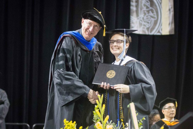 Lauren Rundell receives her master's degree during the 2019 spring commencement
