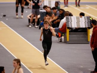 A student-athlete sprints down a runway