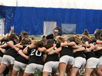 A team huddle for women's lacrosse
