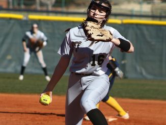 Cami Duffy winds and prepares to release the ball in the pitchers circle.
