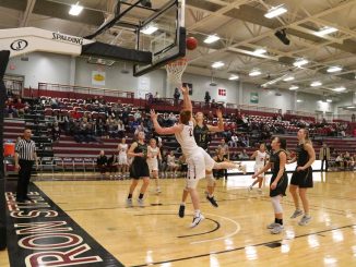 Ellie Moore defenders a shooter underneath the basketball at Chadron State College.