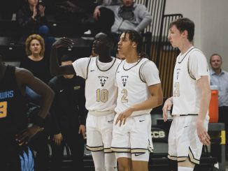 Padiet Wang, Alijah Comithier and William Becker on the sideline for UCCS men's basketball.
