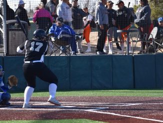 Courtnie Heller waiting for a pitch in the batter's box