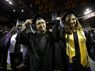 Students move their tassel at a UCCS commencement ceremony