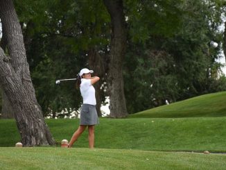 Regina Dillon on the tee box after hitting the ball.