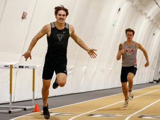 Sam Repsher crosses the finish line in Mountain Lion Fieldhouse
