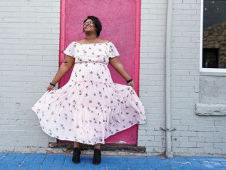 Ashley Cornelius standing in front of a building with a pink door
