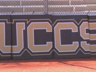 The UCCS letters on the backstop at Mountain Lion Field