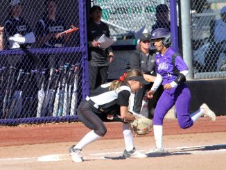 A first base player makes the catch ahead of the tag by a New Mexico Highlands player.