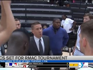 A screenshot of a men's basketball team huddle