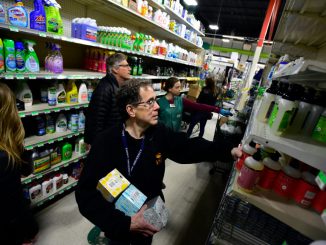A shopper buys soap in a store.