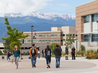Students walk on El Pomar Plaza with Pikes Peak in the background