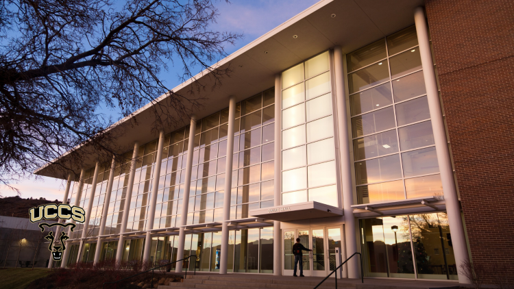 The south side of Dwire Hall, with a sunset reflected in the windows