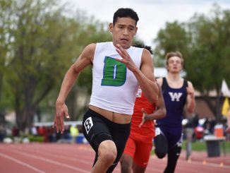 Isaiah Escalante runs on the track during the state championships.