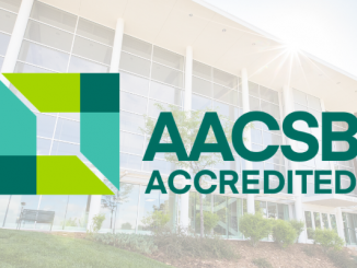AACSB accreditation logo with a faded picture of Dwire Hall in the background