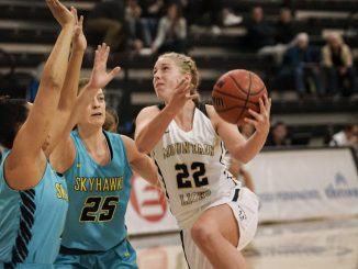 Caley Barnard drives to the rim with a basketball in the Gallogly Events Center