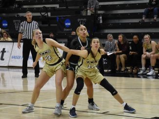 Two Mountain Lion women's basketball student-athletes block out on a free throw in the Gallogly Events Center