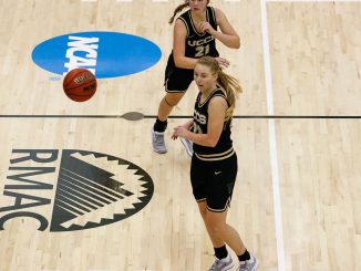 Madi Gaibler passes the ball at the halfcourt line in the Gallogly Events Center