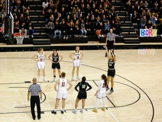 Madison Lord shoots a free throw with the crowd in the background in the Gallogly Events Center