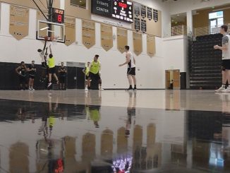 Members of the men's basketball team practice inside Gallogly Events Center