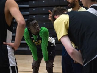 Padiet Wang with his hands on his knees during a break in basketball practice