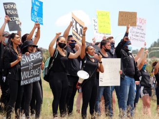 Group of people holding signs for peaceful protest