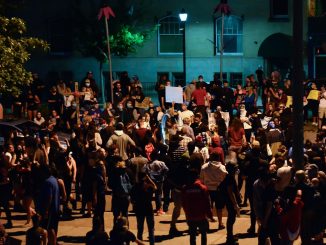 A group of peaceful protesters at night in Colorado Springs