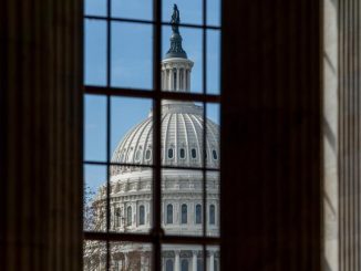 The U.S. Capitol dome as seen through windows from the Russell Senate Office Building.